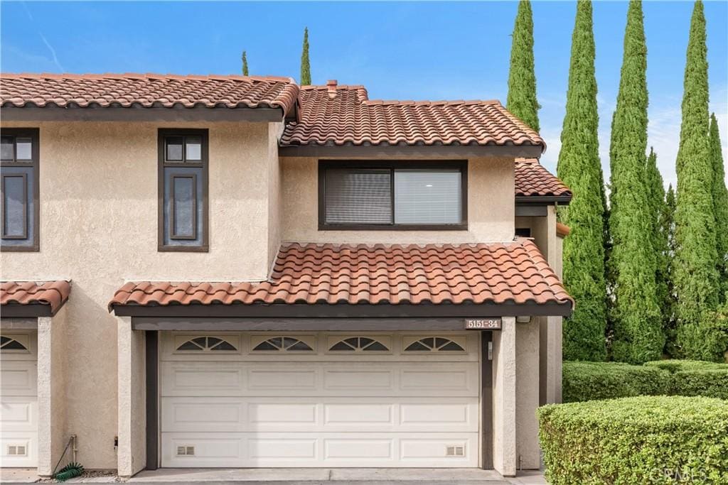 mediterranean / spanish-style house featuring a garage