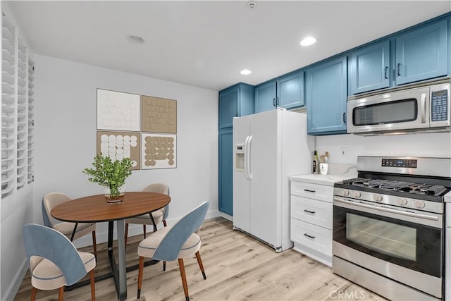 kitchen featuring stainless steel appliances, blue cabinets, and light hardwood / wood-style floors