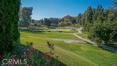 surrounding community featuring a lawn and a rural view