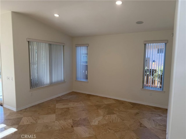 unfurnished room with vaulted ceiling