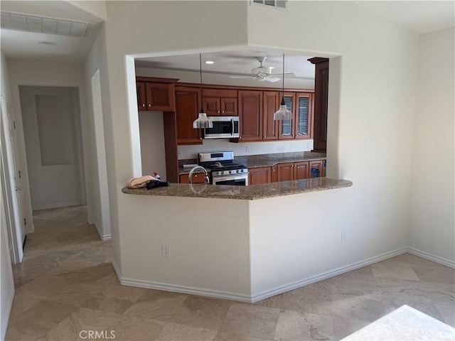 kitchen with ceiling fan, sink, kitchen peninsula, decorative light fixtures, and appliances with stainless steel finishes