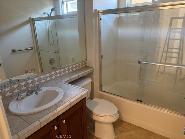 full bathroom with tile patterned floors, vanity, toilet, and enclosed tub / shower combo