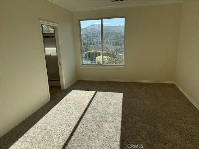 carpeted spare room featuring a mountain view and ornamental molding