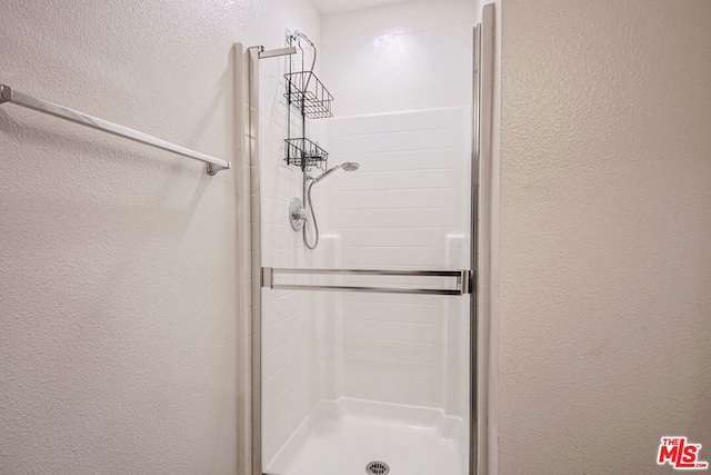 bathroom with a shower with shower door