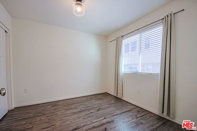 empty room featuring dark wood-type flooring