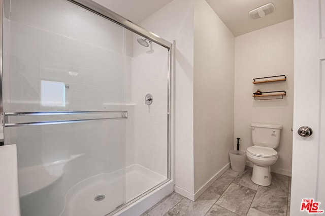 bathroom with an enclosed shower and toilet