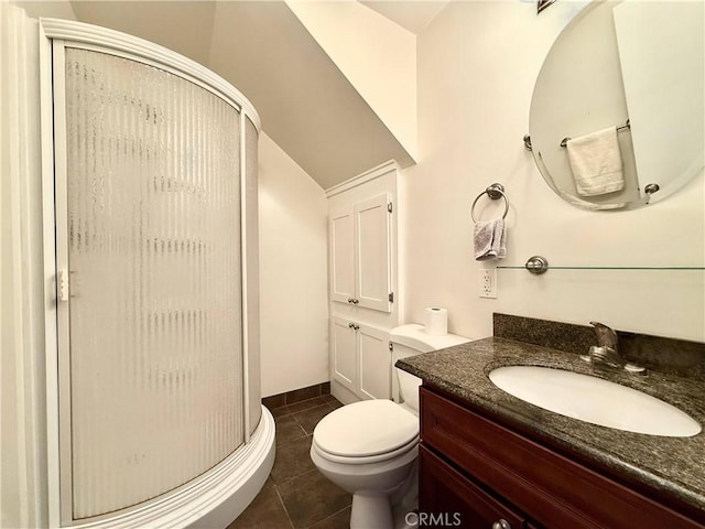 bathroom with toilet, vanity, tile patterned floors, and an enclosed shower