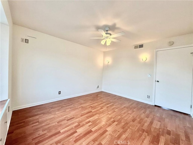 spare room with light hardwood / wood-style flooring and ceiling fan