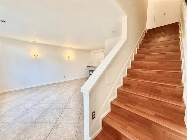 staircase with tile patterned floors