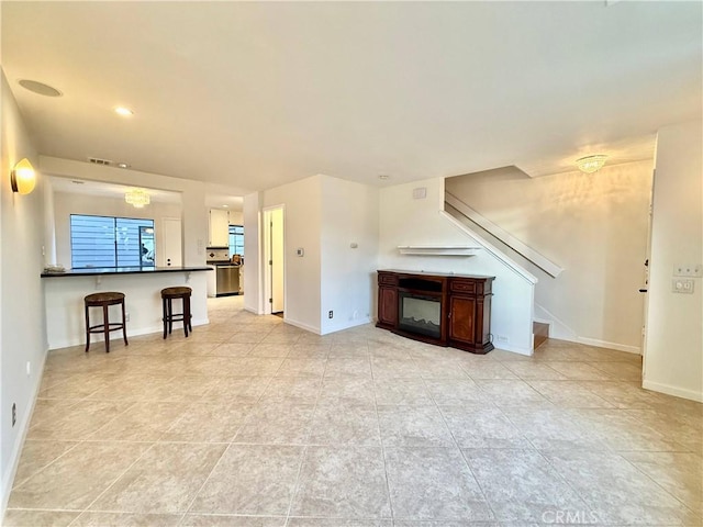 unfurnished living room with an inviting chandelier