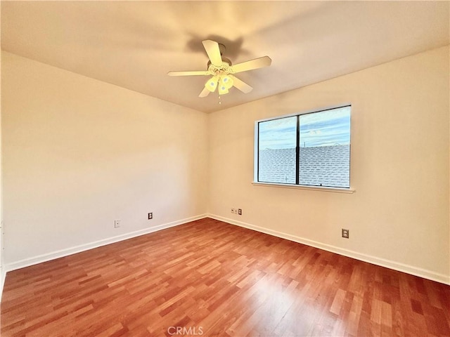 empty room featuring hardwood / wood-style floors and ceiling fan