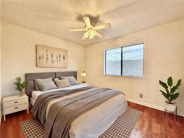 bedroom with ceiling fan and dark wood-type flooring