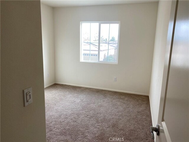 unfurnished room featuring carpet