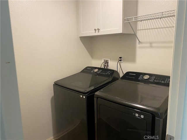 laundry area featuring cabinets and washer and dryer