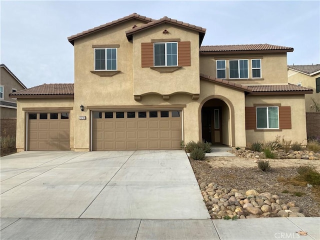 mediterranean / spanish-style home with a garage