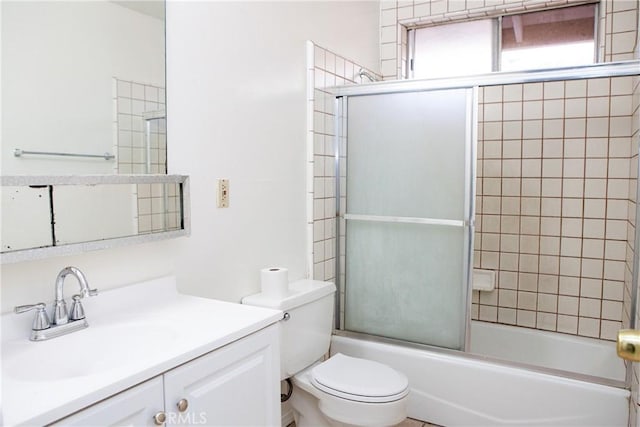 full bathroom with vanity, toilet, and shower / bath combination with glass door