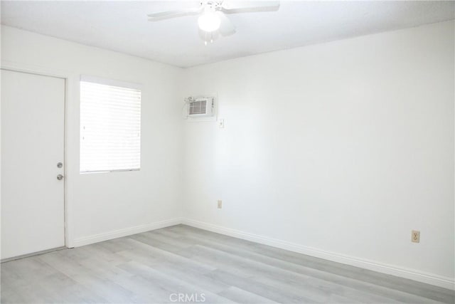 unfurnished room featuring ceiling fan, light hardwood / wood-style floors, and an AC wall unit