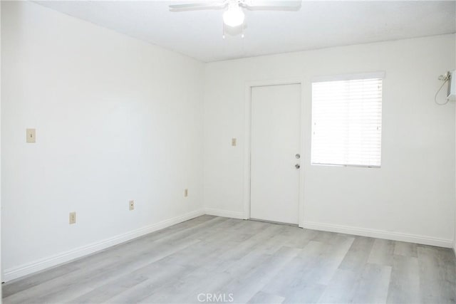 empty room with light hardwood / wood-style flooring and ceiling fan