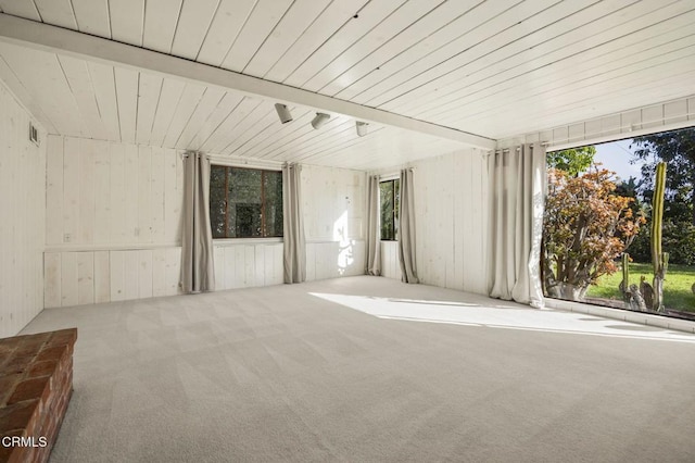 carpeted empty room featuring wooden ceiling