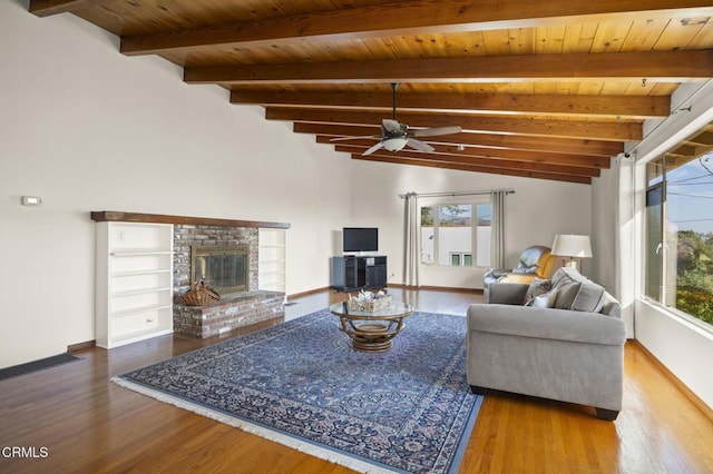 living room featuring a fireplace, lofted ceiling with beams, plenty of natural light, and wooden ceiling