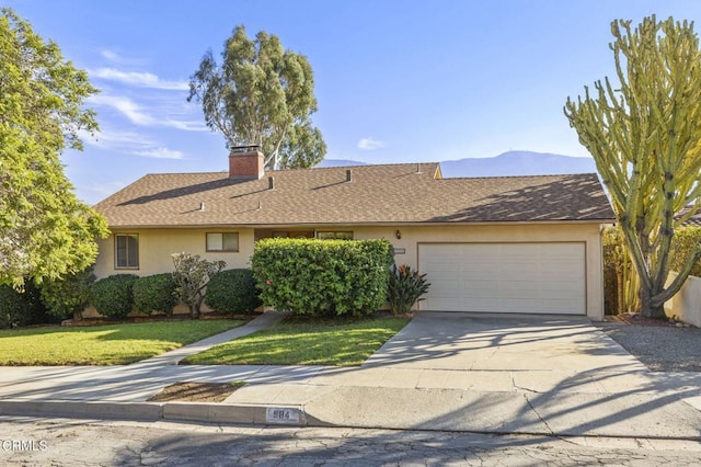 ranch-style house featuring roof with shingles, a chimney, stucco siding, concrete driveway, and a garage