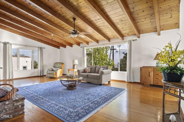 living area featuring vaulted ceiling with beams, wooden ceiling, a wealth of natural light, and wood finished floors