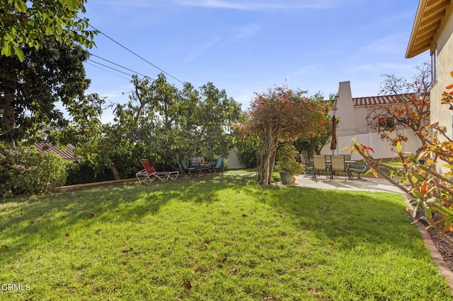 view of yard featuring a patio and fence