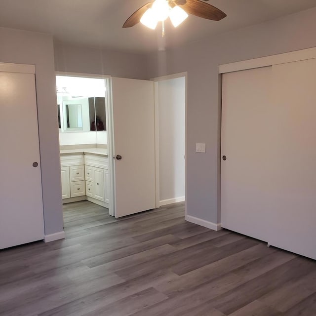 unfurnished bedroom with ensuite bath, ceiling fan, and light wood-type flooring