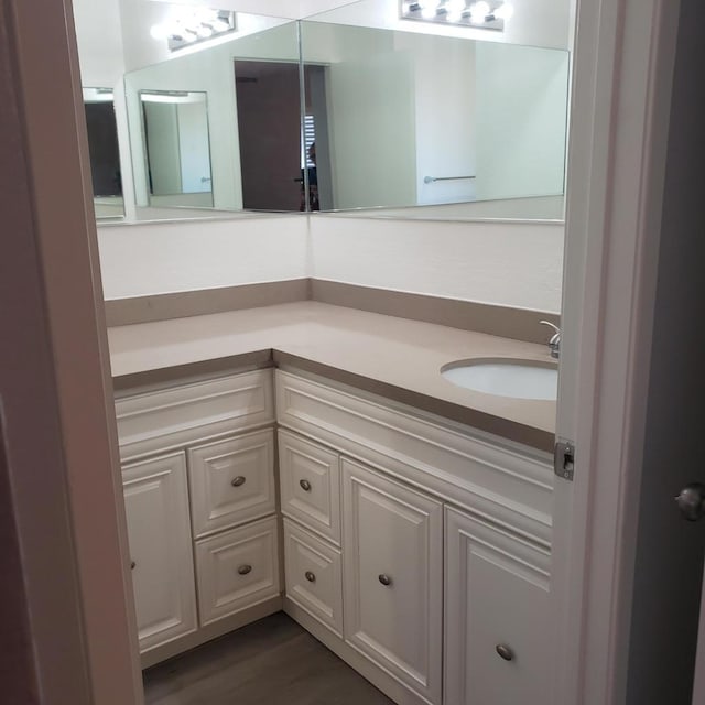 bathroom featuring vanity and wood-type flooring