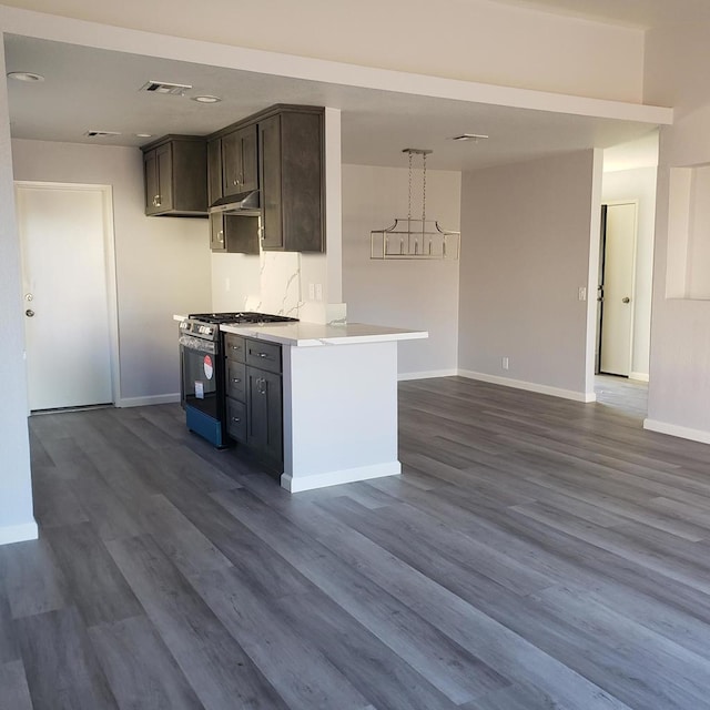 kitchen with dark wood-type flooring, range with gas stovetop, and dark brown cabinets