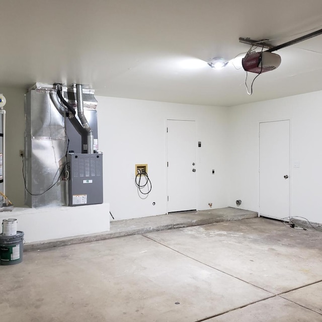 garage with a garage door opener and heating unit