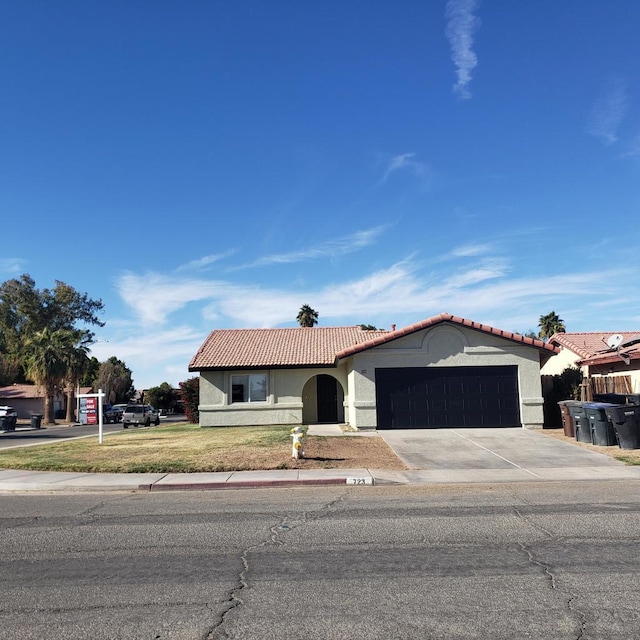 view of front of property with a garage and a front lawn