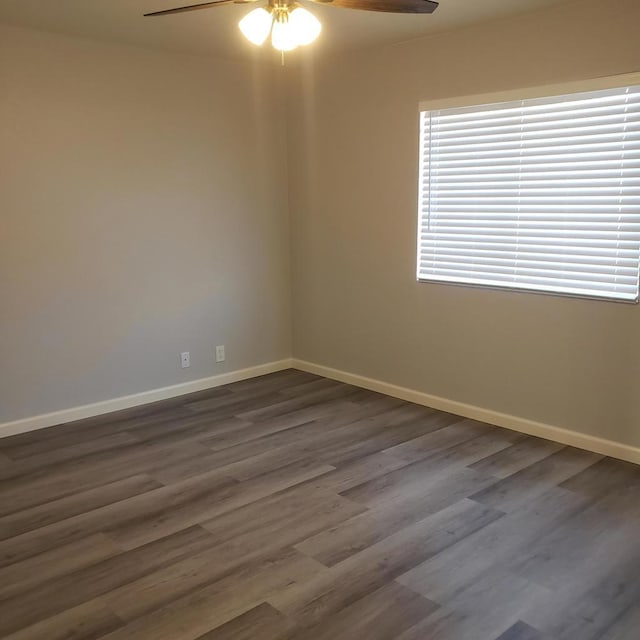 empty room featuring ceiling fan and dark hardwood / wood-style flooring