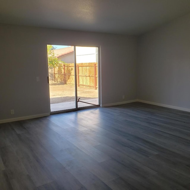 unfurnished room featuring dark hardwood / wood-style flooring