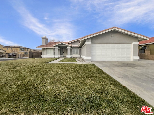 view of front of home with a front yard and a garage