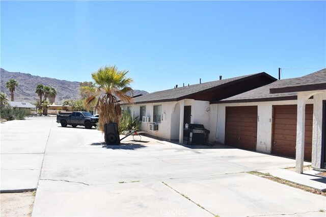 view of front of house with a mountain view and a garage