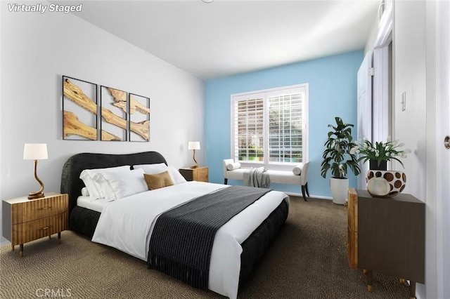 bedroom with dark colored carpet