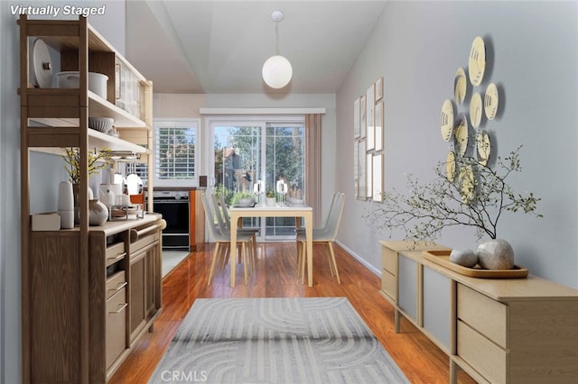 interior space with light hardwood / wood-style flooring and vaulted ceiling