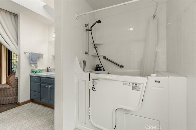 bathroom with vanity and a shower