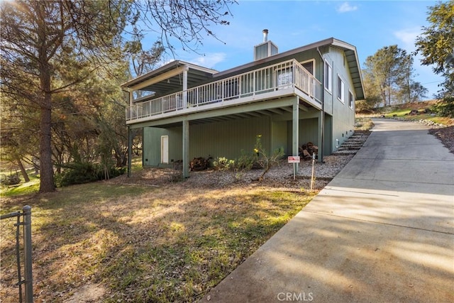 back of property featuring a deck and a chimney