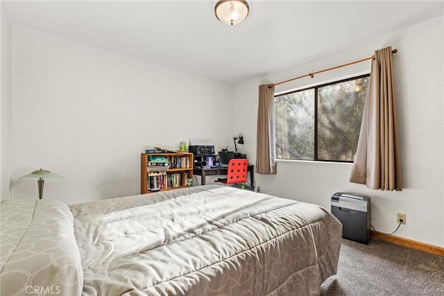 bedroom with baseboards and carpet floors