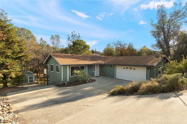 ranch-style home with an outbuilding, a storage shed, an attached garage, and driveway