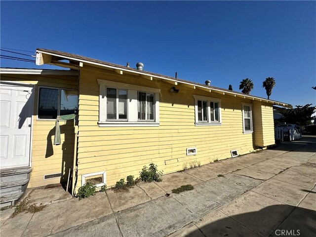 view of property exterior with a patio area