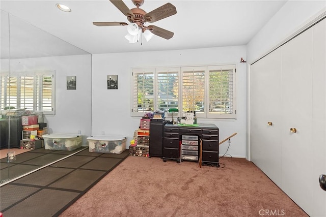 home office featuring ceiling fan, a healthy amount of sunlight, and carpet flooring