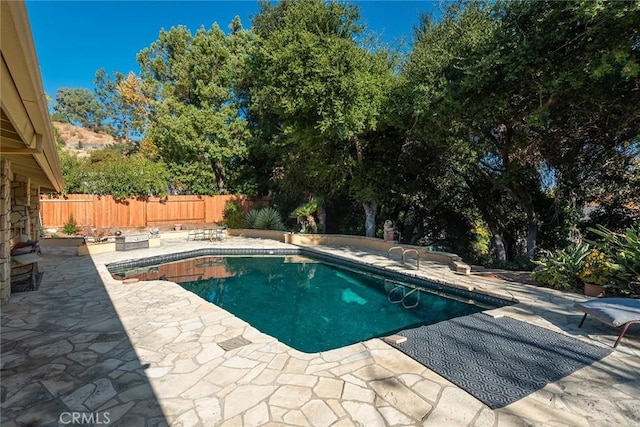 view of swimming pool featuring a patio area