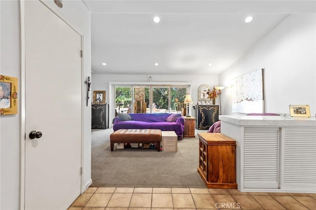 carpeted bedroom with lofted ceiling