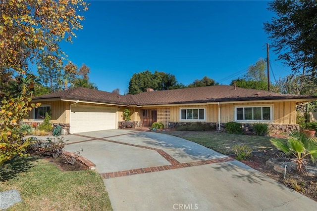 single story home with a garage and a front yard