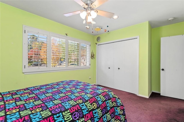 carpeted bedroom featuring ceiling fan and a closet