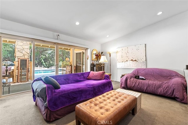 carpeted bedroom featuring access to outside, vaulted ceiling, and multiple windows