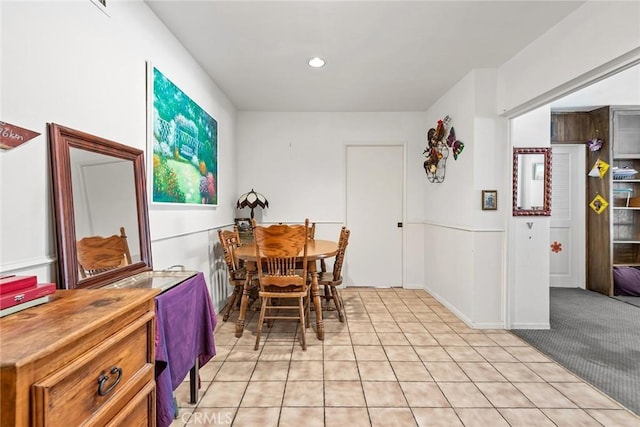 dining area featuring light carpet